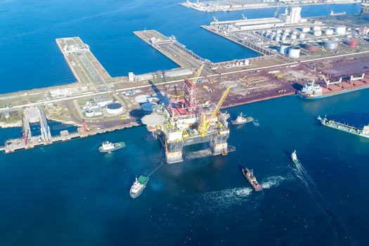 Drilling platform in the port. Towing of the oil platform.