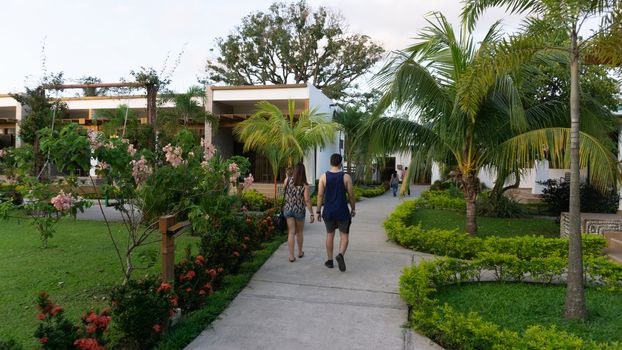 Couple walking between a garden