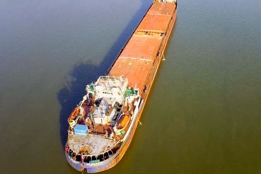 A cargo barge floats along the river. Cargo ship