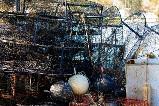 Close up shot of nets, fish traps and apparatus of professional fisherman on the shore