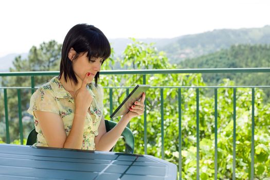 casual woman working with a tablet pc, outdoor