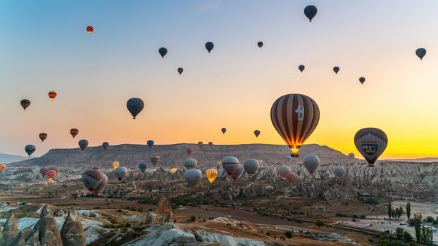 Colorful hot air balloon flying over Cappadocia, Turkey.