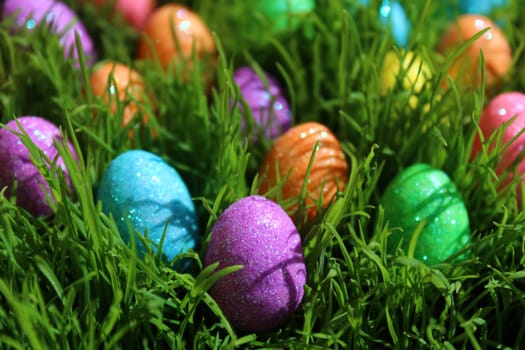 The picture shows colourful eastereggs in eastergrass