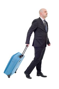 Full length side view of young businessman with luggage walking isolated on white background