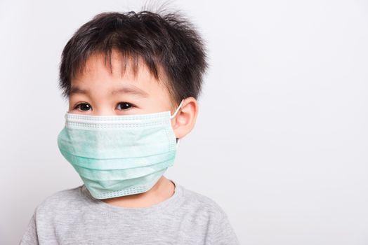 Closeup Asian face, Little children boy sick he using medicine healthcare mask on white background with copy space, health medical care