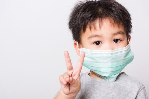 Closeup Asian face, Little children boy sick he using medicine healthcare mask on white background with copy space, health medical care