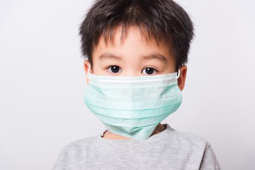 Closeup Asian face, Little children boy sick he using medicine healthcare mask on white background with copy space, health medical care