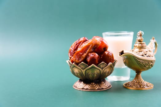 Ramadan, Dates in golden bowl, Milk, arabian Aladdin golden lamp vintage style on black green background