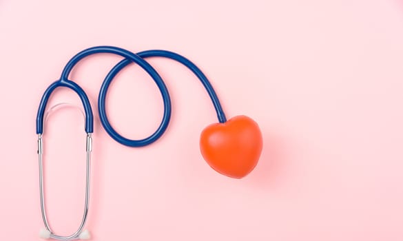 World health day concept, Stethoscope, globe and red heart on pink background with copy space. Global health care