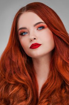 A beauty shot of a young woman with red hair and beauty make-up