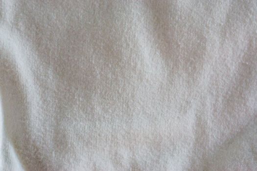 macro closeup of a pure white clean cotton fabric, popular material for clothing