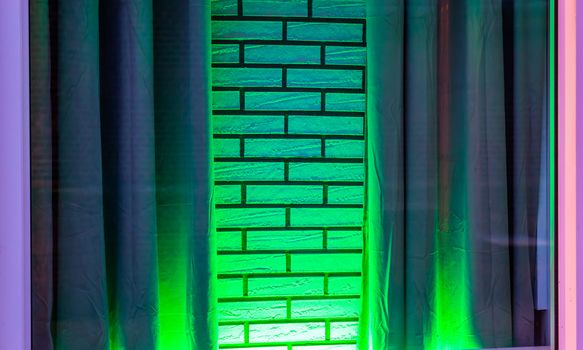 green neon light shining on a white brick wall with curtains, modern decorative background