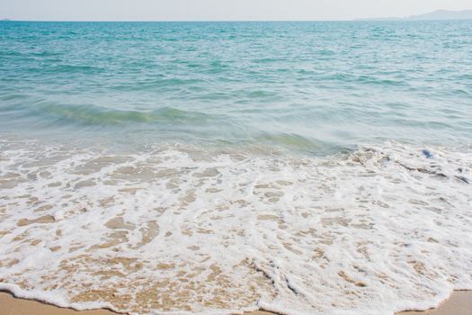 Close-up details of small ocean waves That blows ashore at the beach