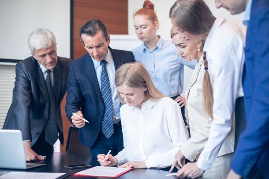 Team work process, business people sign contract documents standing near the table