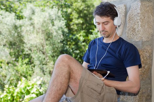 casual man working with a tablet pc, outdoor