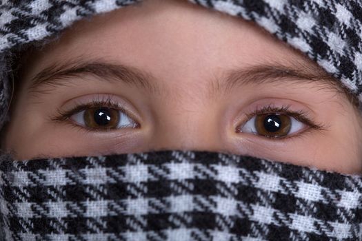 young girl with a veil covering her, close up, studio picture