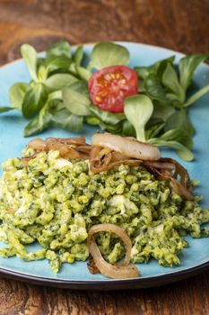 bavarian spinach spaetzle on a blue plate