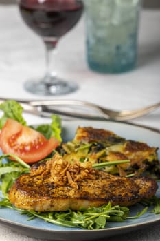 grilled pork steak on lambs lettuce