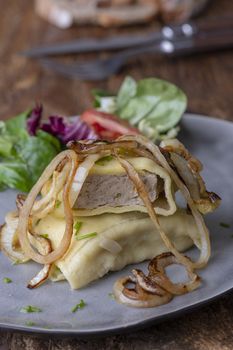 swabian maultasche with onions on a plate