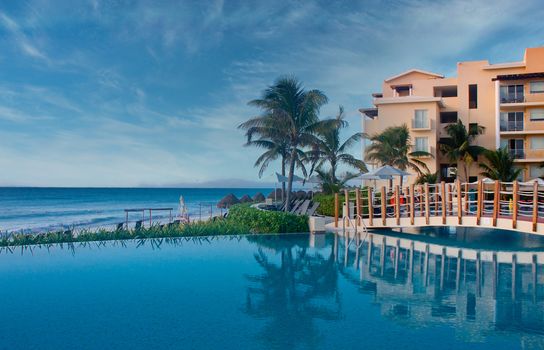 Swimming pool on a tropical beach at dawn