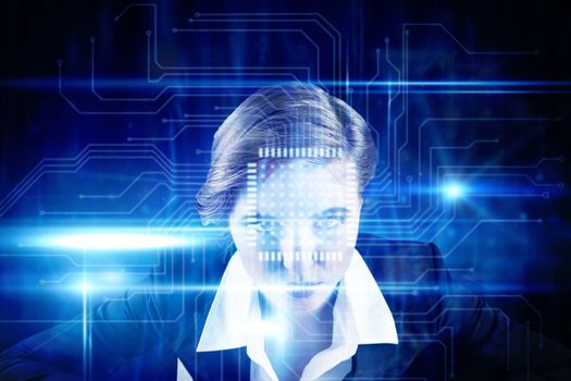 Focused businesswoman against blue technology interface with circuit board