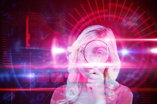 Fair-haired woman looking through a magnifying glass against red technology interface with light