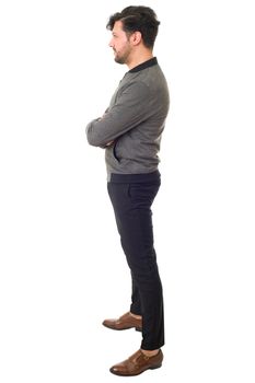 young casual man full body from the side in a white background