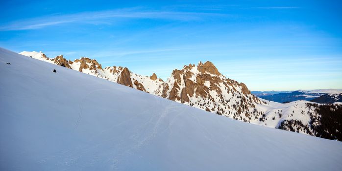 Panoramic view of Mount Ciucas peak at a sunset on winter, part of Romanian Carpathian Range