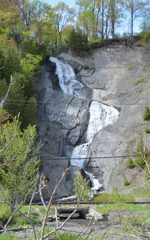 waterfall or cascade with rocks on hill in Quebec Canada