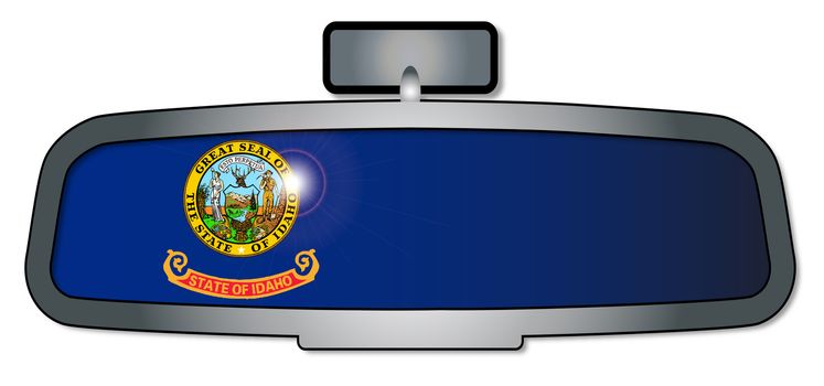 A vehicle rear view mirror with the flag of the state of Idaho