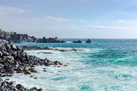 Ocean wave background breaking sea water rocky shore at Tenerife Islan, Spain