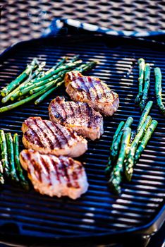Pork chops and asparagus on grill surface