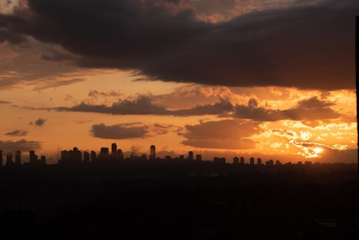 Urban area silhouette on sunset sky background