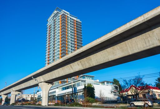 Skytrain rail lane in front of residential tower building
