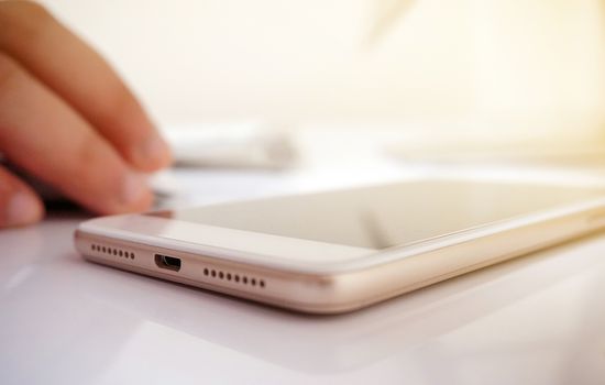 White phone placed in the desk. Essential equipment for office work