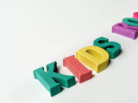 Children's colored letters placed on a white background.