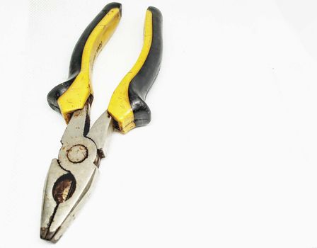 Pliers with yellow and black handles placed on a white background