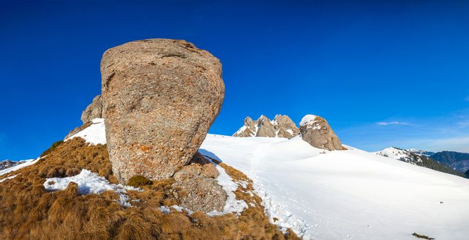 Panoramic view with rocks from Mount Ciucas peak on winter, part of Romanian Carpathian Range
