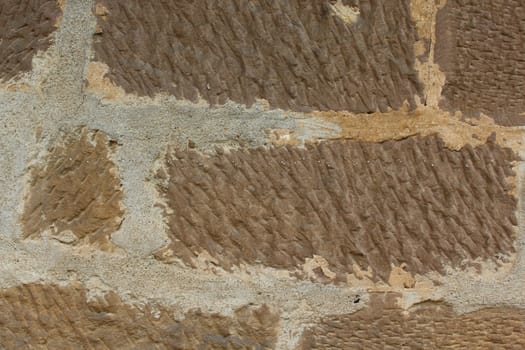 The picture shows brown stone wall