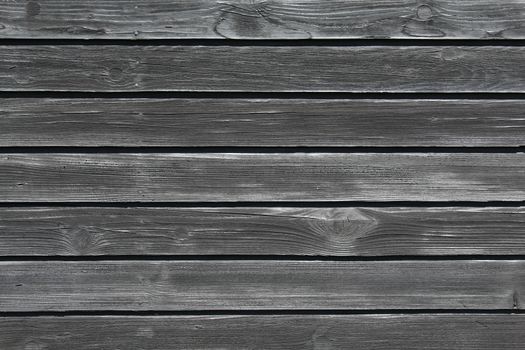 The picture shows a black wooden background with boards