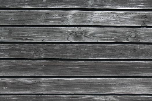 The picture shows a black wooden background with boards