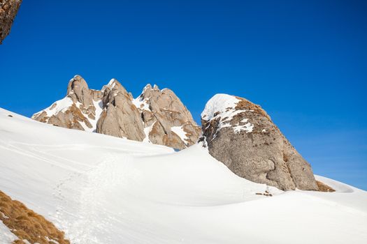 View of Mount Ciucas peak on a sunny winter day with beautiful rock formations, part of Romanian Carpathian Range