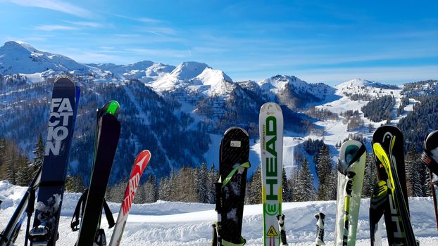 Skis In The Snow on Ski Piste With Against snowy Mountains