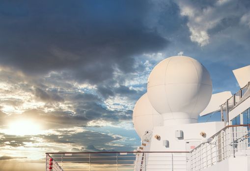 Communication equipment on a cruise ship under clear blue skies