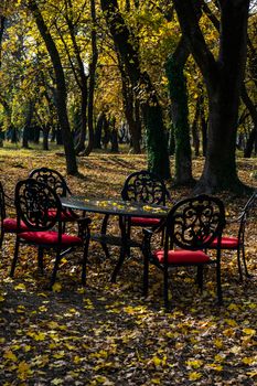 Table and chairs in autumnal park of Chateau Mukhrani close to Tbilisi, travel in Georgia