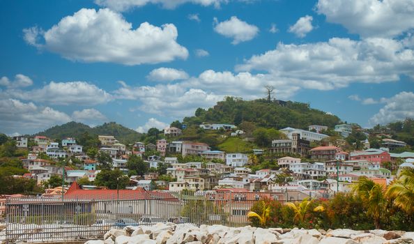 Colorful homes covering a seaside hill on the Caribbean island of Dominica