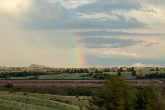 A rainbow over a field. High quality photo