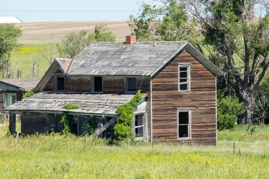 A old abandon farmhouse with a grass field of Wyoming. High quality photo