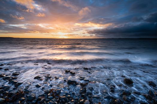 Dawn on Belfast Lough, viewed from Downshire beach, Carrickfergus, County Antrim, Northern Ireland.