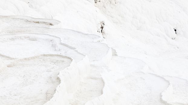 The view across a white travertine terrace in Pamukkale, southwestern Turkey.  The site is a UNESCO World Heritage Site.